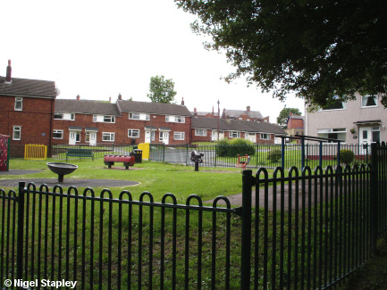 Picture of houses with a play area in front of them