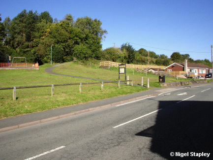 Photo looking across a road to a green area