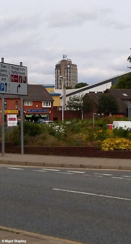 Picture of a public baths with an unusual design with a concrete tower block next to it