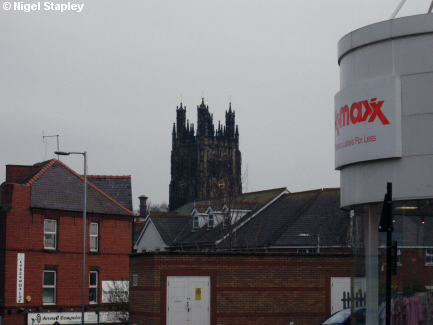 Picture of a church tower seen over town rooftops