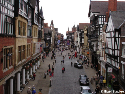 Picture of a city street taken from the wall which crosses it