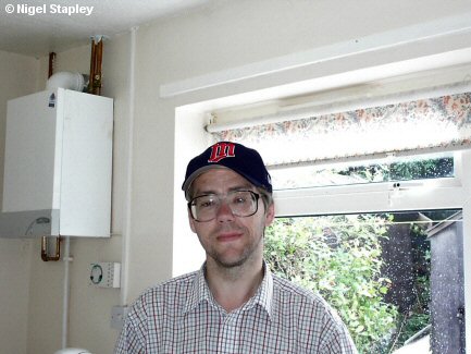 Photo of a man standing in his kitchen