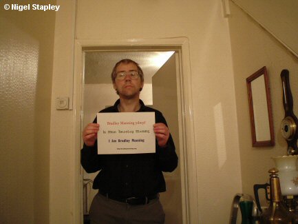 Photo of a man holding up a sign saying 'I Am Bradley Manning