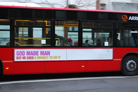 Bus sign saying 'God made man, but he used a monkey to do it'