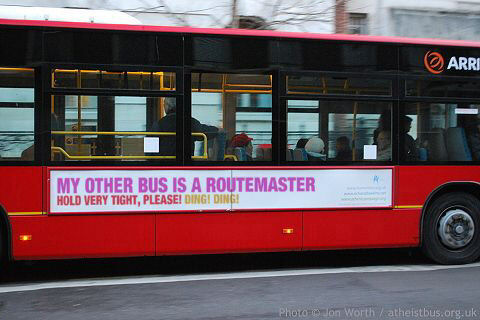 Bus sign saying 'My other bus is a Routemaster. Hold very tight, please! Ding! Ding!'