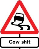 'Slippery road' sign with reason given as 'Cow shit'
