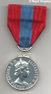 Photo of the obverse side of the Imperial Service Medal and its ribbon