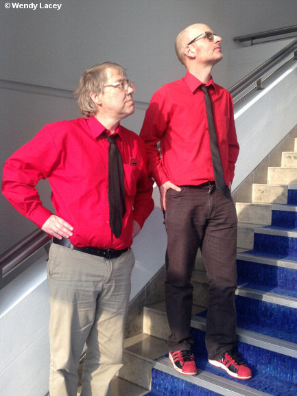 Photo of two men posing as robots on a staircase