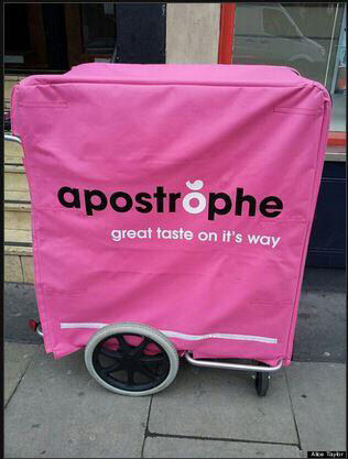 Photo of a trolley saying 'Apostrophe - Great Taste On It's Way'