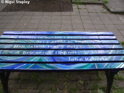 Photo of a bench with a poem painted on it