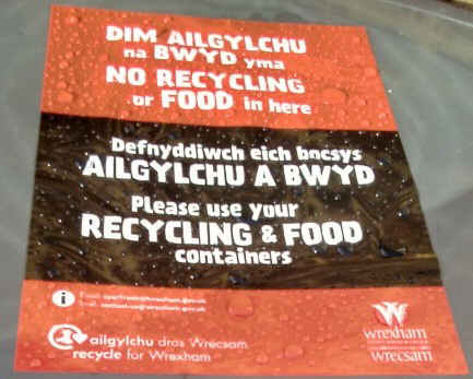 Photo of a sticker on a domestic bin warning the resident to use the proper recycling bin