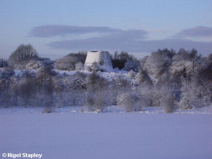 Photo of an old industrial chimney in the snow