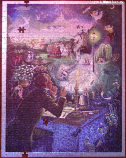 Photo of a jigsaw puzzle (incomplete) of a painting of Hans Christian Anderson and his characters