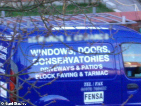 Picture of blue van, where 'Driveways' and 'Patios' are spelt with apostrophes