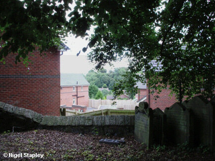 Photo of some new houses taken over a stone wall