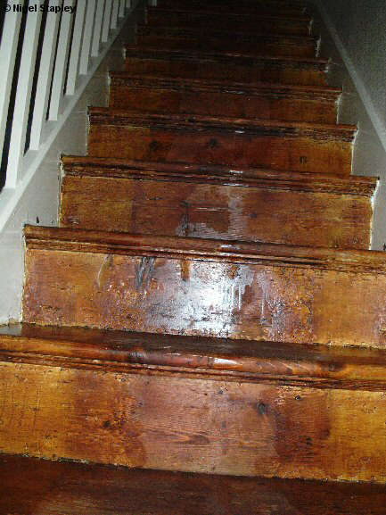 Photo looking up some woodstained stairs