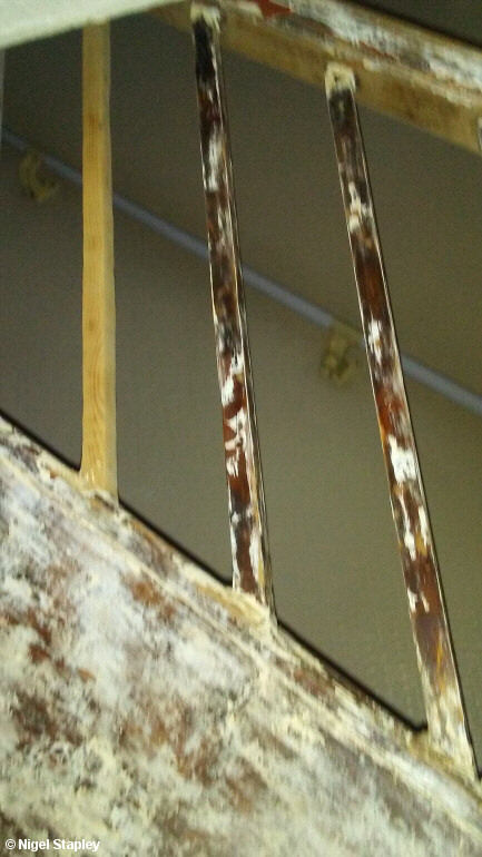 Photo of partly-sanded spindles on a banister