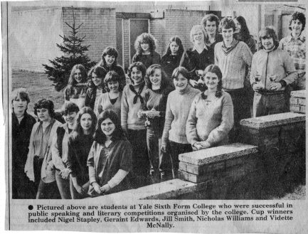 Newspaper photo of a group of students, some of them holding small trophies